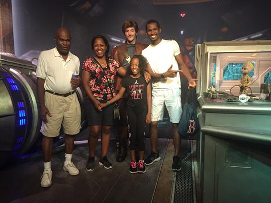 Family members enjoy their time together while posing in a themed entertainment venue.