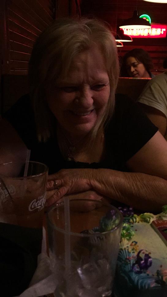 Laughter and good company are shared at a lively restaurant as friends enjoy dinner together.