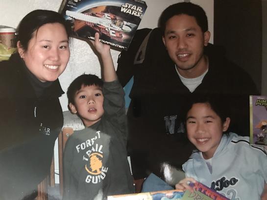 Parents and children share joyful moments exploring new toys and games together at home.