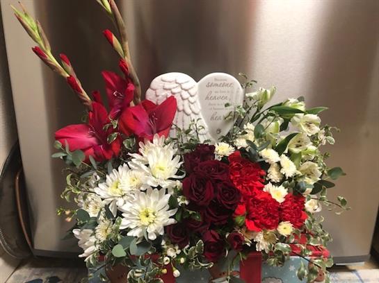 This vibrant floral display features red and white blooms, celebrating love and remembrance.