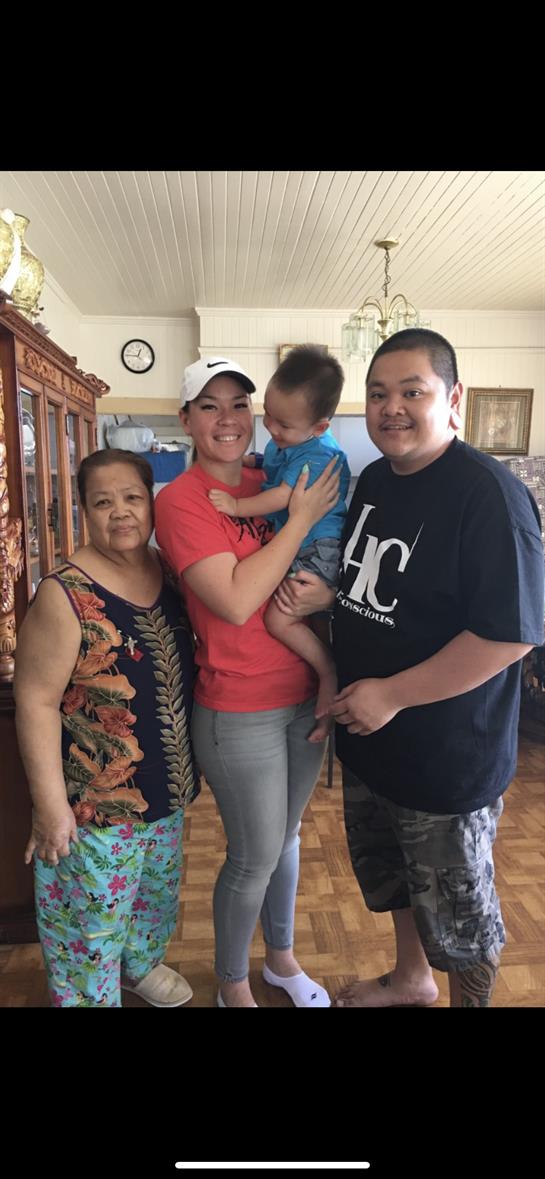 Four family members enjoy a heartfelt moment together in a warm living space.