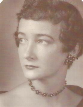 A stylish woman with short hair and exquisite jewelry poses confidently, showcasing her elegance.