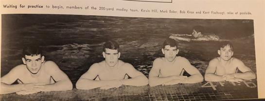 Two swimmers pose at the edge of a pool, showing their focus and readiness for competition.
