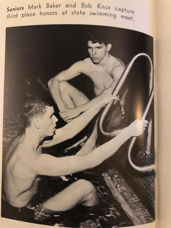 Two boys are sitting by a pool, one is adjusting a ladder while the other watches closely.