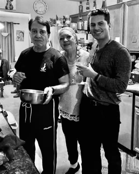 Friends and family enjoy cooking together in a warm kitchen, sharing laughter and joy.