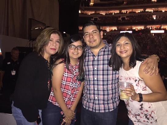 Friends pose together at a lively concert, enjoying their time in the energetic atmosphere.