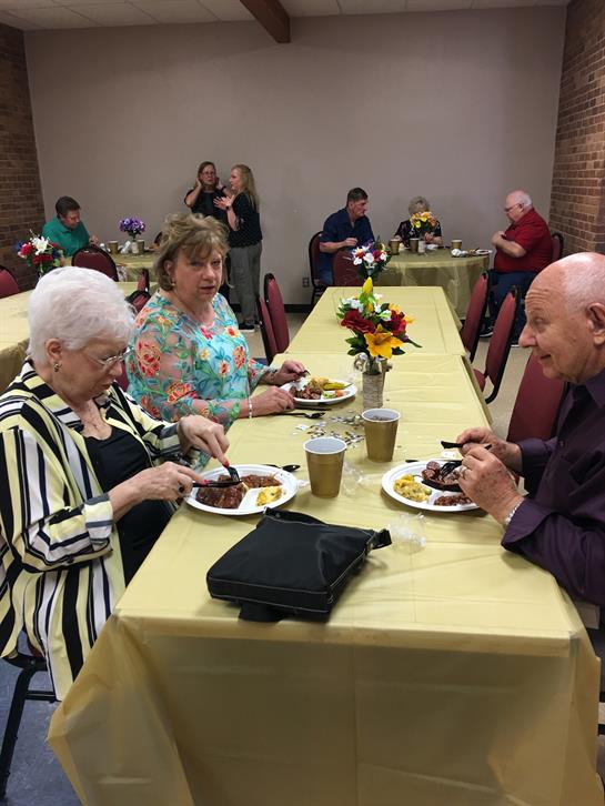 Guests savor mouthwatering dishes while engaging in lively discussions at a community event.