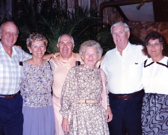 Six friends gather together in a lively atmosphere, enjoying a memorable evening celebration.