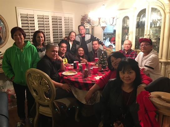 A group of family members enjoys a festive dinner together, sharing laughter and stories.