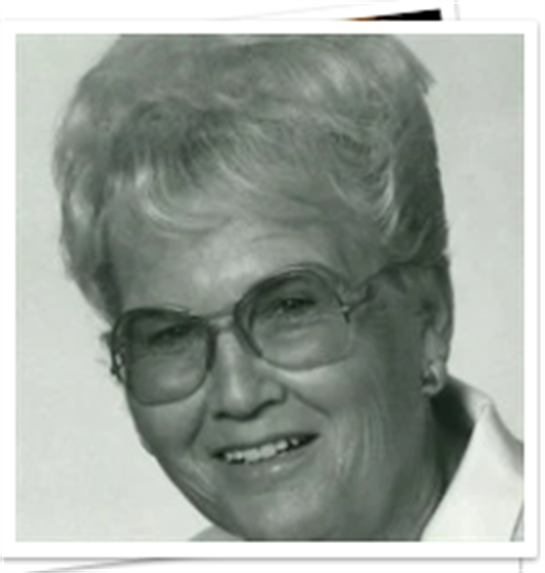 A joyful elderly woman with glasses smiles warmly, reflecting a sense of happiness and nostalgia.