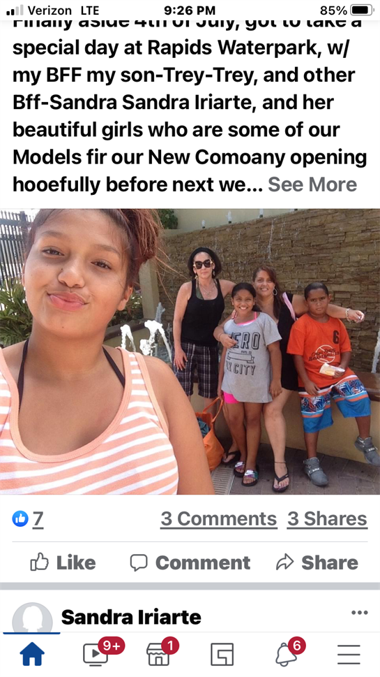 Friends gather for a fun day out, posing happily near a water feature under sunny skies.