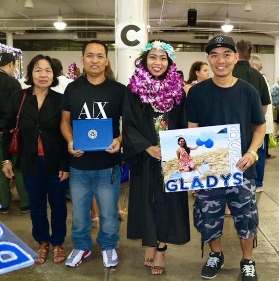 Family and friends gather at a community center to celebrate graduation with joy and pride.