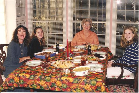 A family gathering brings together generations for a meal and seasonal decorations.