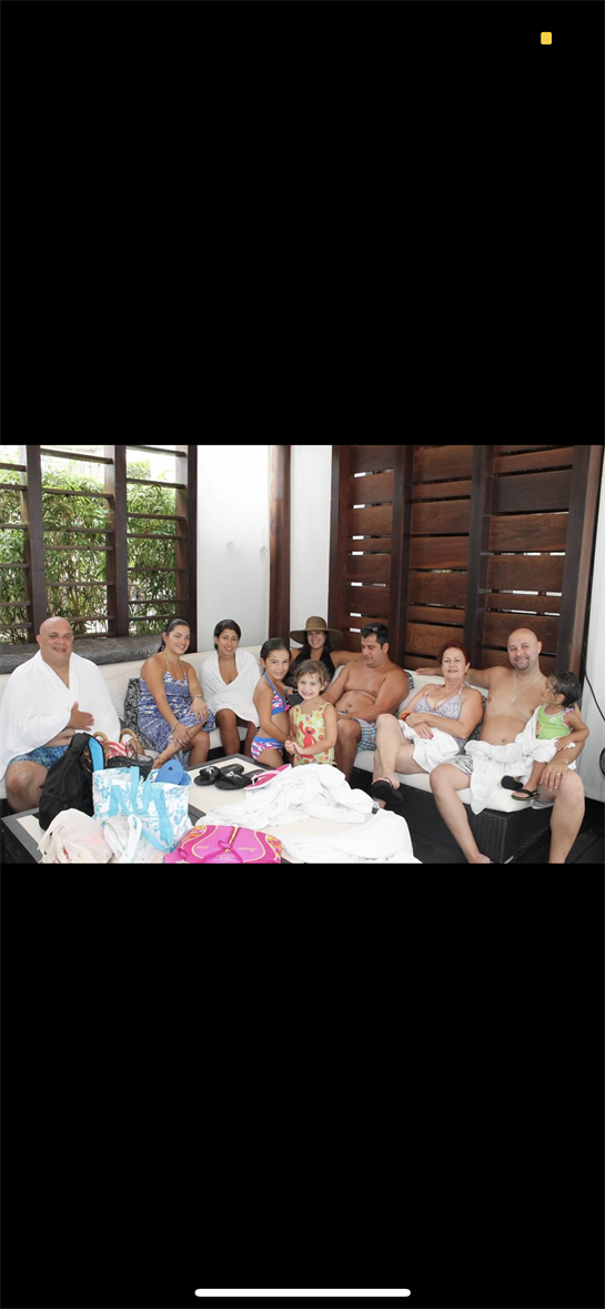 Family members enjoy quality time together in a tropical resort lounge, sharing laughter and warmth.