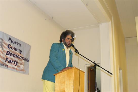 A politician speaks at a community event, sharing insights and engaging attendees with enthusiasm.