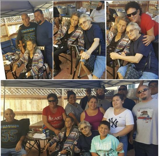 Group of family members celebrates together outdoors, sharing laughter and stories under a tent.