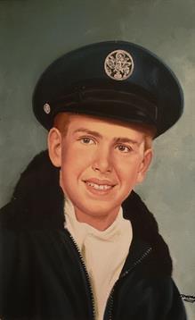 A cheerful young man wears a uniform and hat, smiling confidently with a light background.