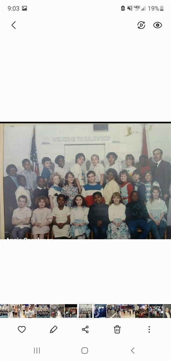 Students and teachers unite for a class photo, highlighting diversity and togetherness.