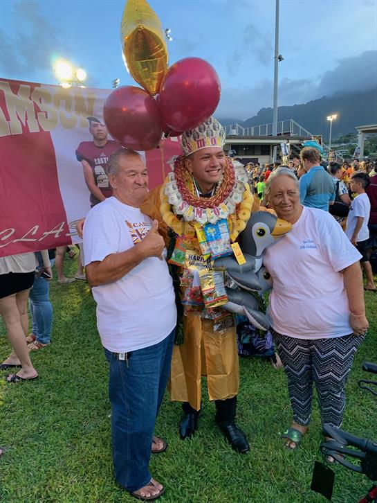 Festive gathering showcasing traditions with people wearing vibrant outfits and smiling together.