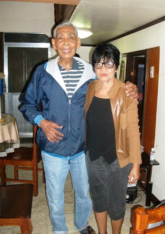 Two people smile and enjoy their time together in a warm, relaxed living space.