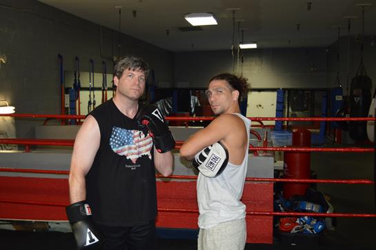 Two athletes gear up for box training in a local gym, showcasing their determination and focus.