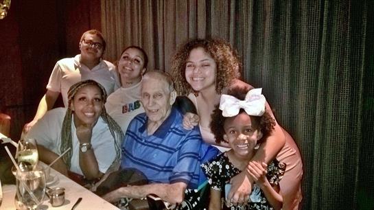 A group of six people enjoys quality time together in a cozy restaurant setting.