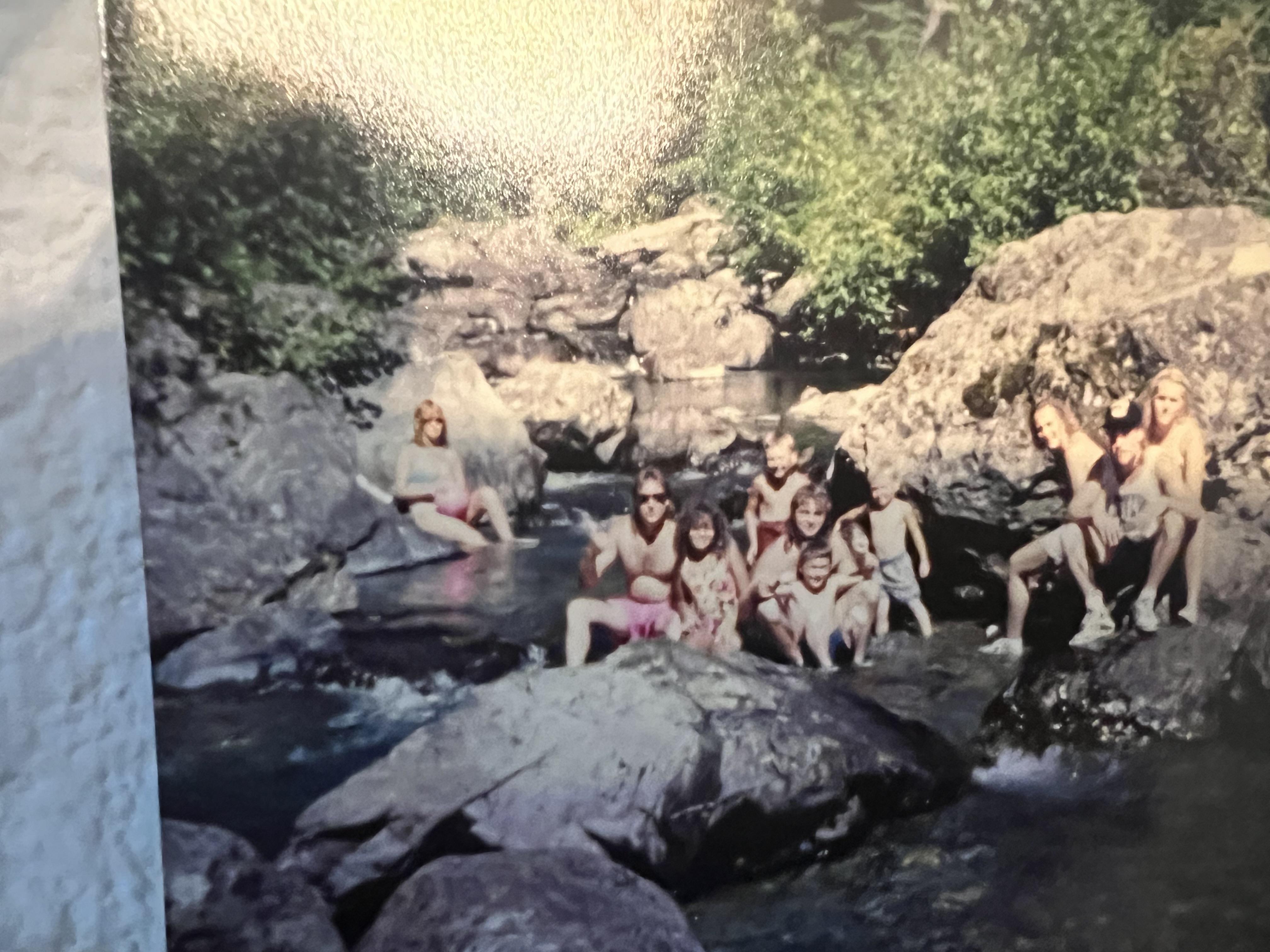 A group of people sitting in a river