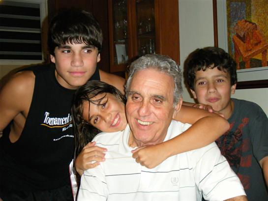 A grandfather and his grandchildren share a joyful, heartfelt moment together.