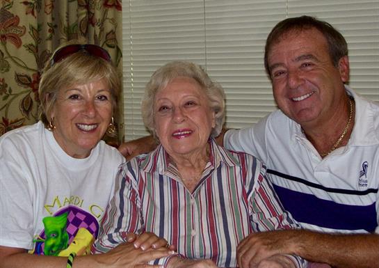 Members of a family share warmth and smiles during a visit with their grandmother at home.