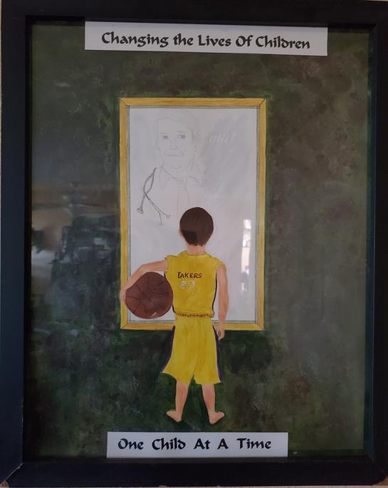 A young boy stands with a basketball, analyzing plays on a whiteboard during practice.