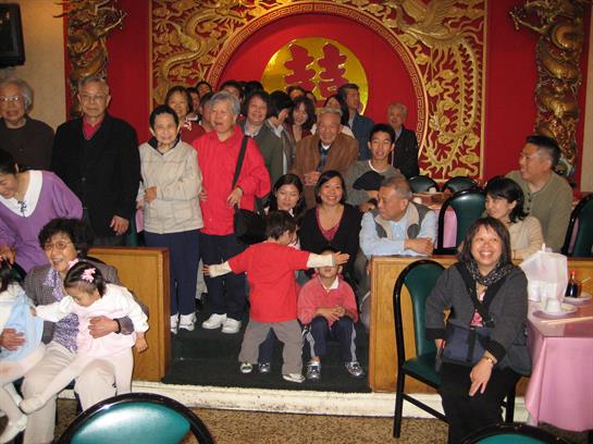 Families celebrate together in a vibrant venue adorned with lively decorations.