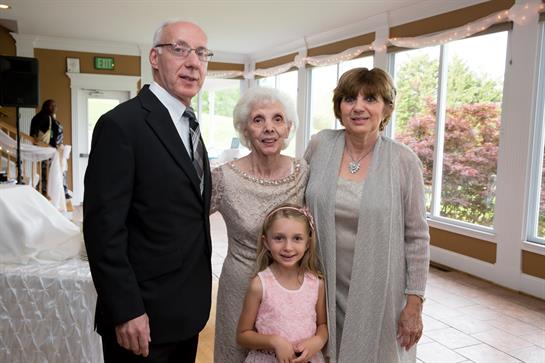 A happy family stands together, showcasing love and connection during a memorable gathering.