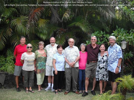 Group of friends and family poses together in a lush garden in Hawaii during their reunion.