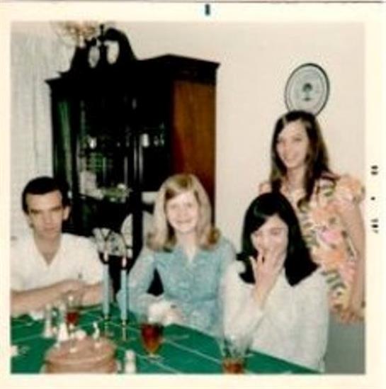 Four friends enjoy refreshments and conversation at a cozy home gathering in the afternoon.