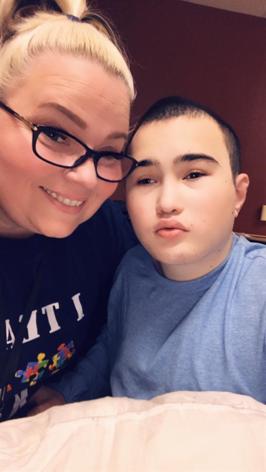 Smiling individuals enjoy a warm moment together in a relaxed indoor setting during the evening.