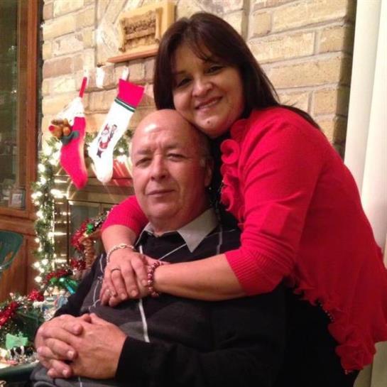 A couple enjoys a warm moment during Christmas, surrounded by holiday decorations and a tree.