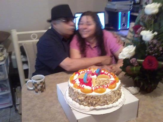 Family members celebrate with cake and laughter in a warm, inviting living room.