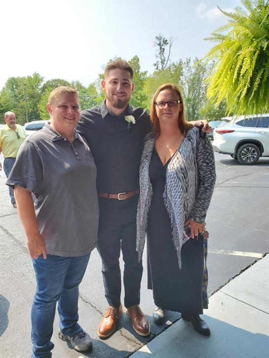 Group captures a joyful moment during a gathering outdoors with friends in sunny weather.