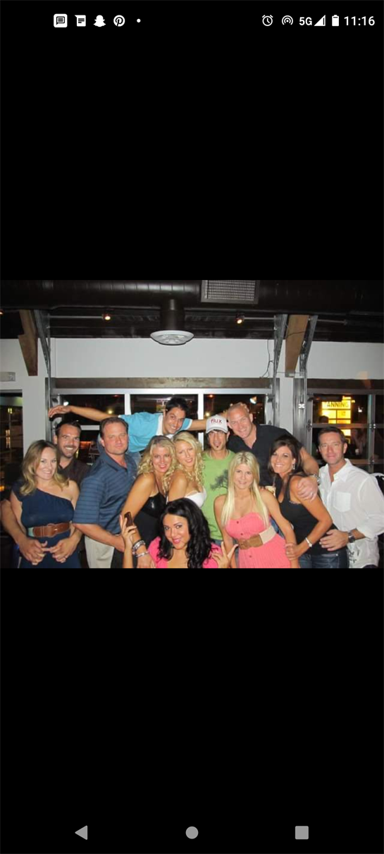 Friends gather for a fun night out in a vibrant restaurant, enjoying each other's company.