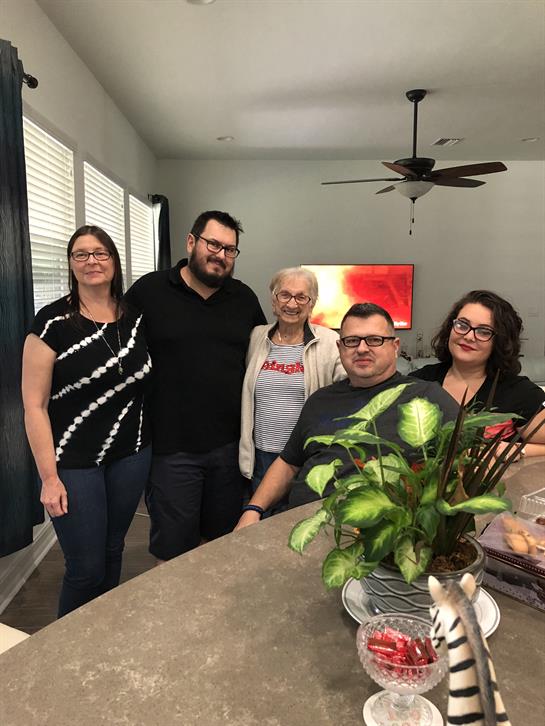 Family members share laughter and conversation in a warm, inviting living space together.