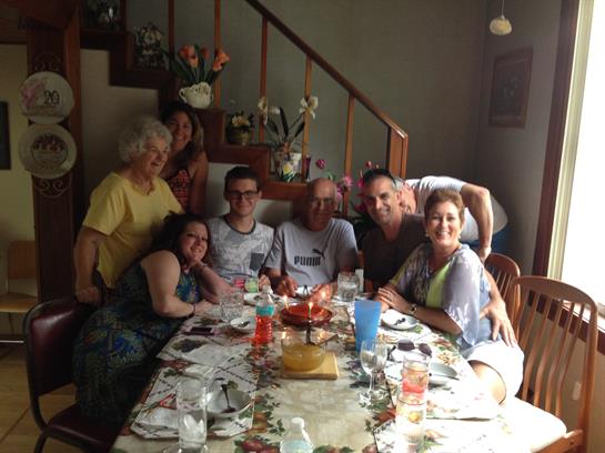 Family members enjoy a meal together, celebrating connection and warmth in a cheerful atmosphere.