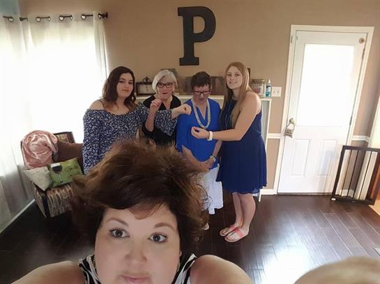 Five friends come together in a warm living room, sharing smiles and laughter during a reunion.