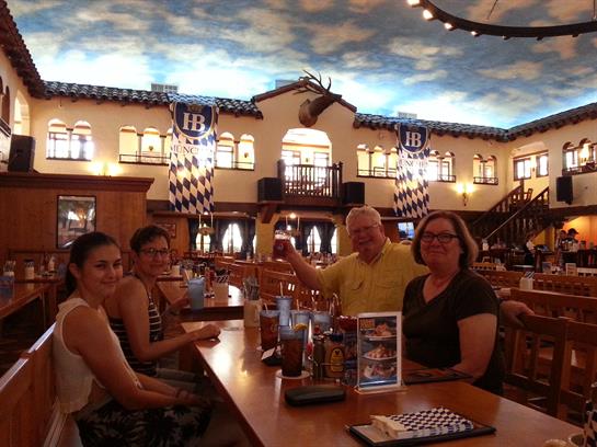 Friends enjoy a meal together at a vibrant restaurant adorned with artistic details.