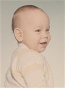 A happy baby turns their head, beaming with joy and lovely features.