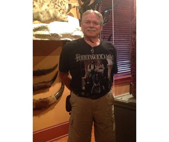 Individual stands confidently in a room filled with taxidermy displays, enjoying the atmosphere.