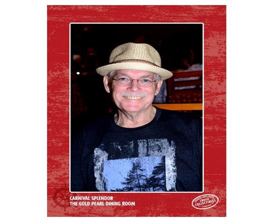 A cheerful man wearing a straw hat and a casual shirt smiles brightly while dining.