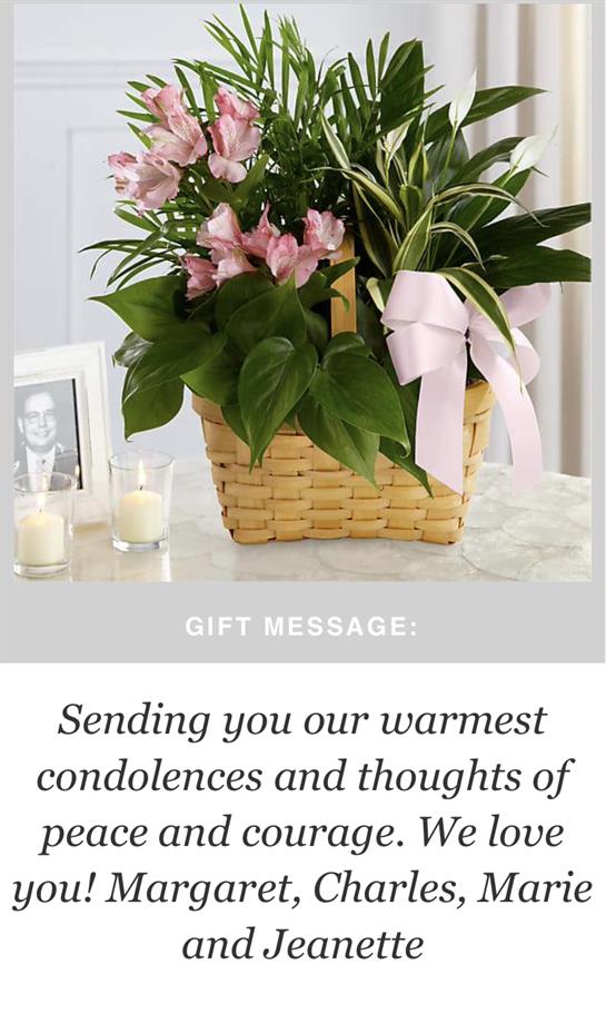 A beautifully arranged floral gift in a woven basket, perfect for sharing condolences and support.