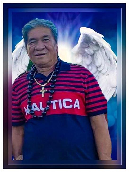 A joyful man poses with angel wings, wearing a striped shirt and necklace, smiling brightly.