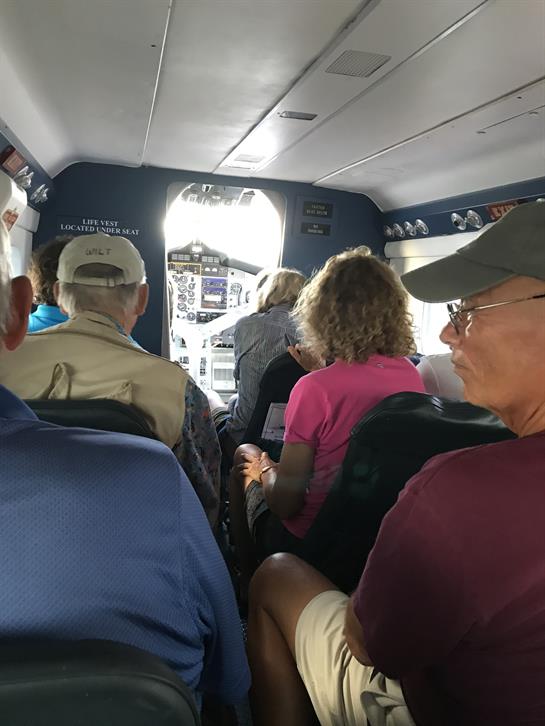 Passengers are excitedly settling into their seats as the small aircraft prepares for takeoff.