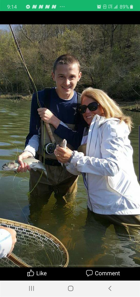 Couple catches fish while enjoying quality time together on a clear afternoon at the lake.